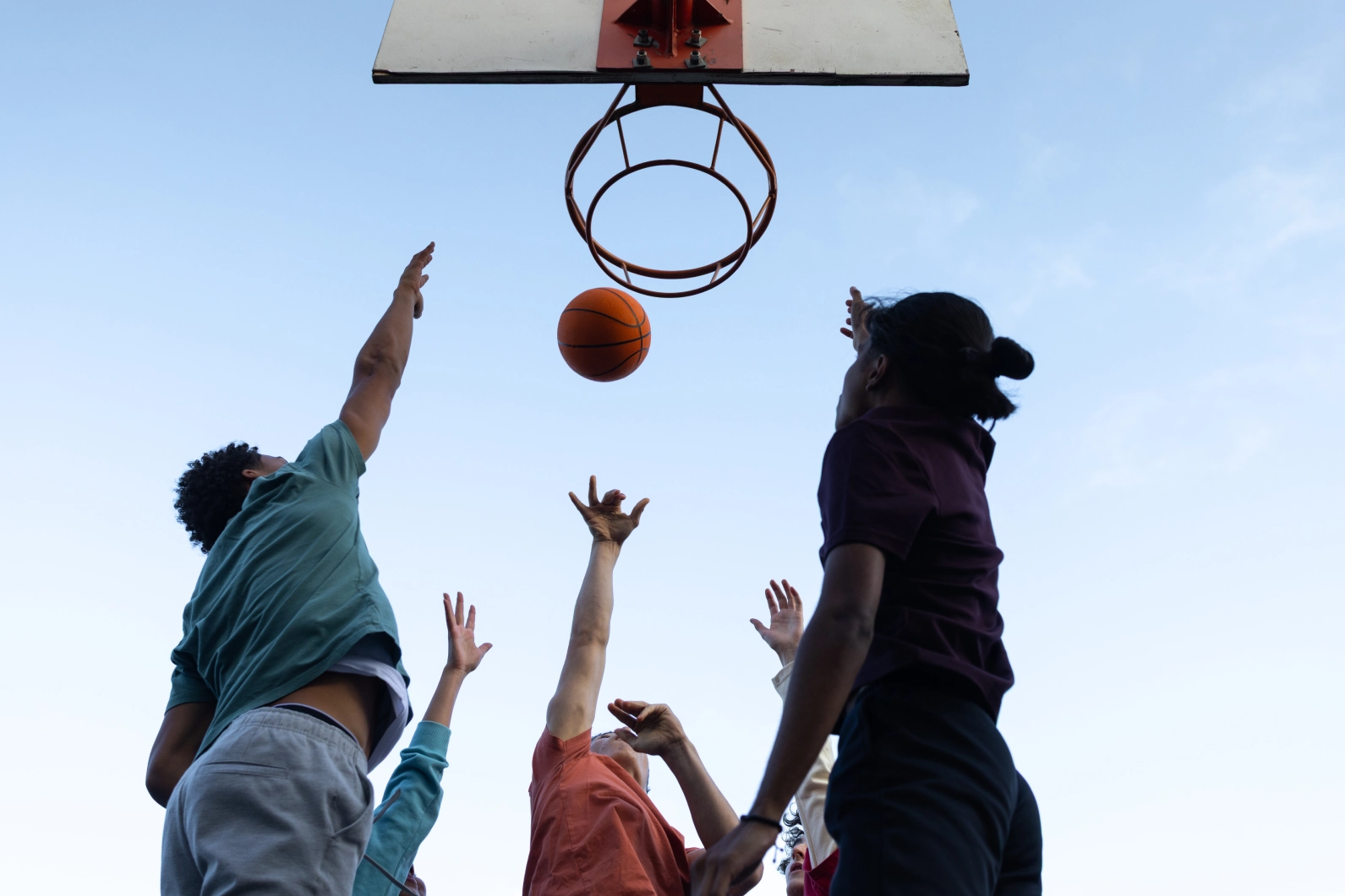 Teens shooting hoops together